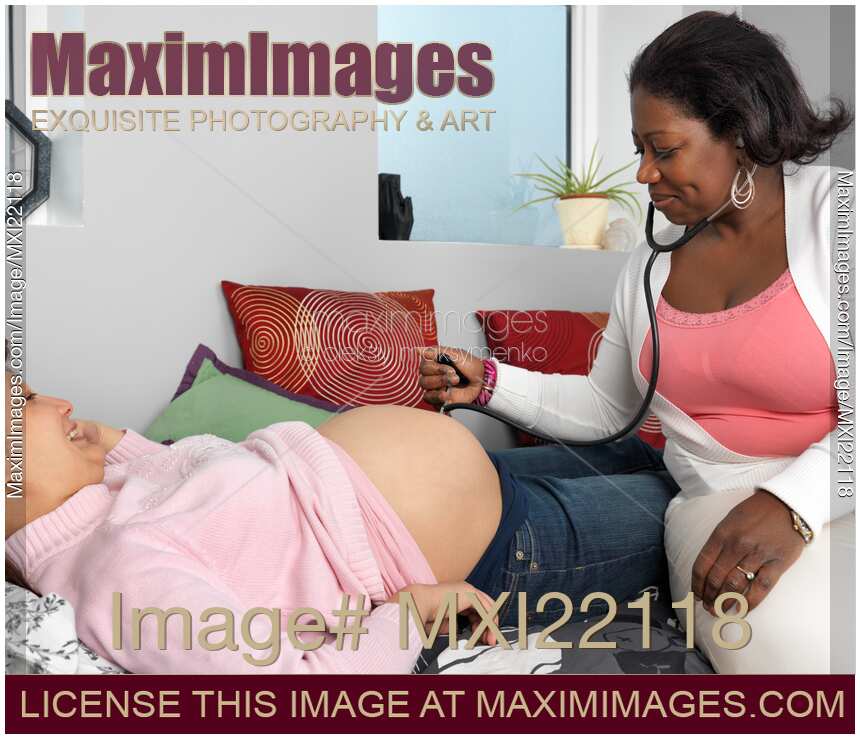 Midwife Checking Pregnant Woman Baby's Heartbeat