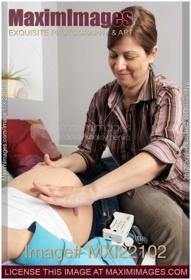 Midwife Inspecting a Pregnant Woman