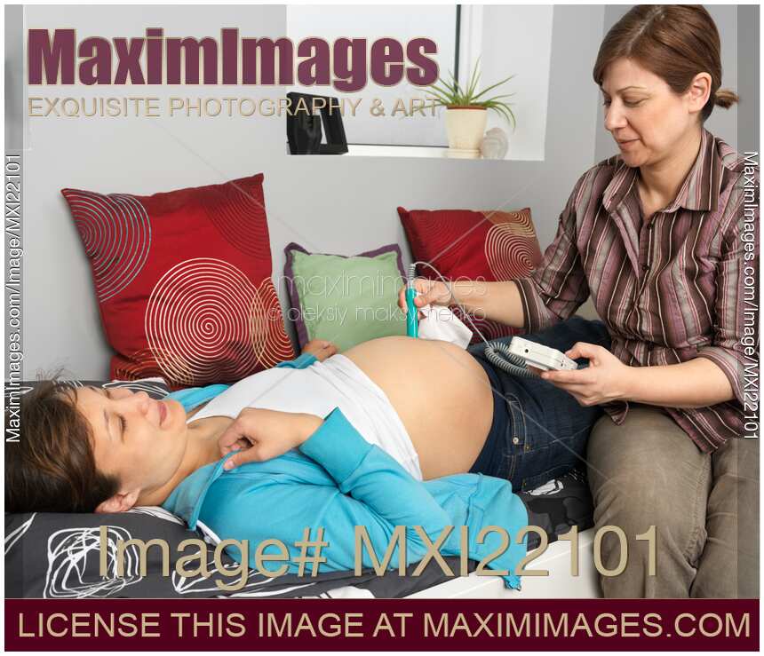 Midwife Monitoring a Pregnant Woman's Baby Heartbeat