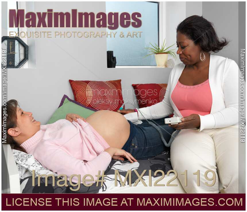 Midwife Monitoring a Pregnant Woman's Baby Heartbeat