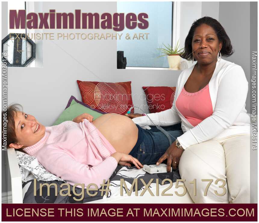 Midwife Monitoring a Pregnant Woman's Baby Heartbeat