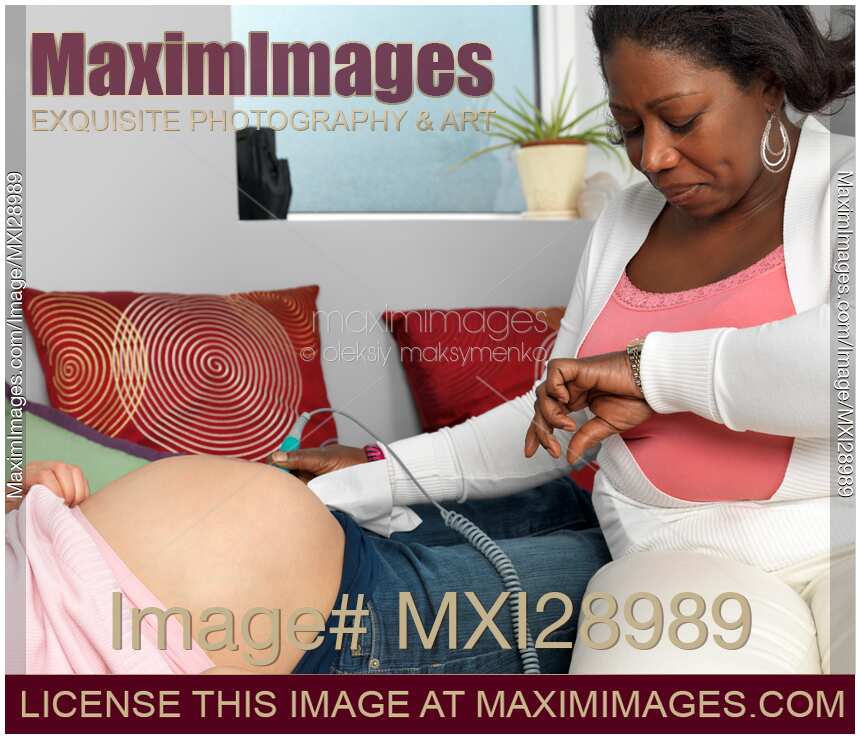 Midwife Monitoring a Pregnant Woman's Baby Heartbeat