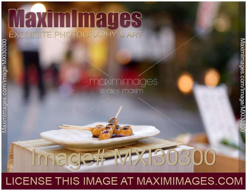 Mitarashi Dango steaming Japanese sweet grilled dumpling balls on a skewer food still life