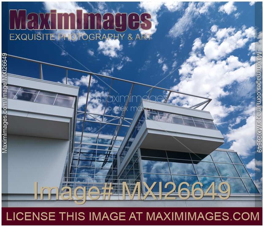 Modern building of glass and metal under blue sky with clouds