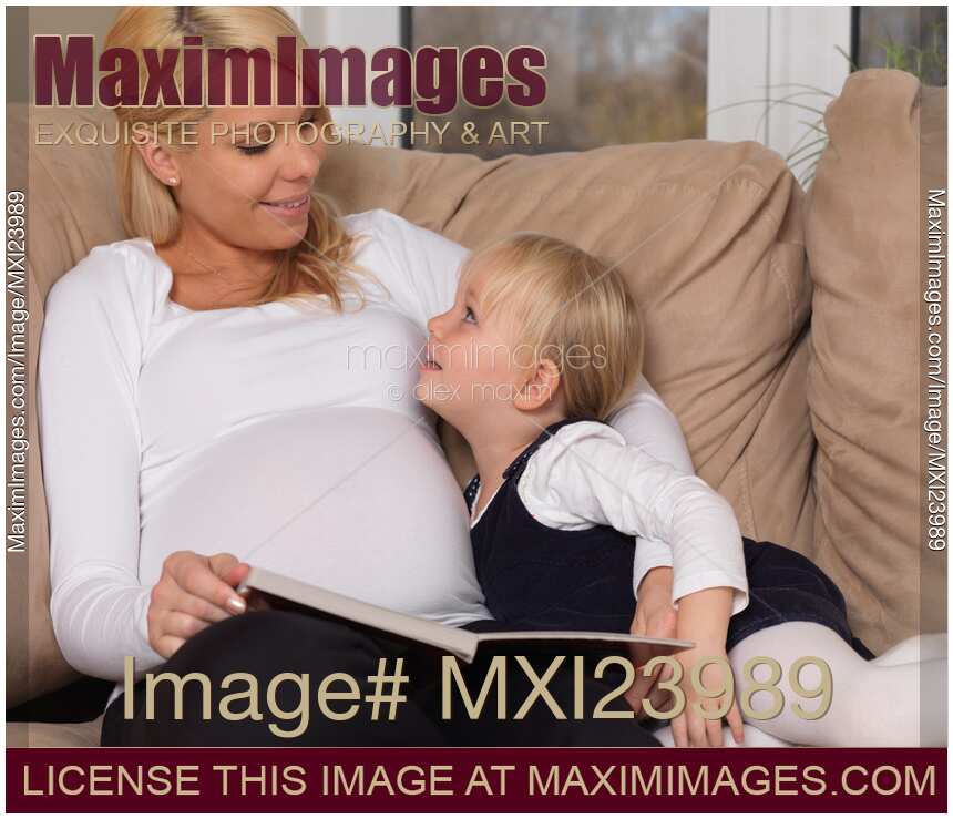 Mother and her little daughter reading a book together
