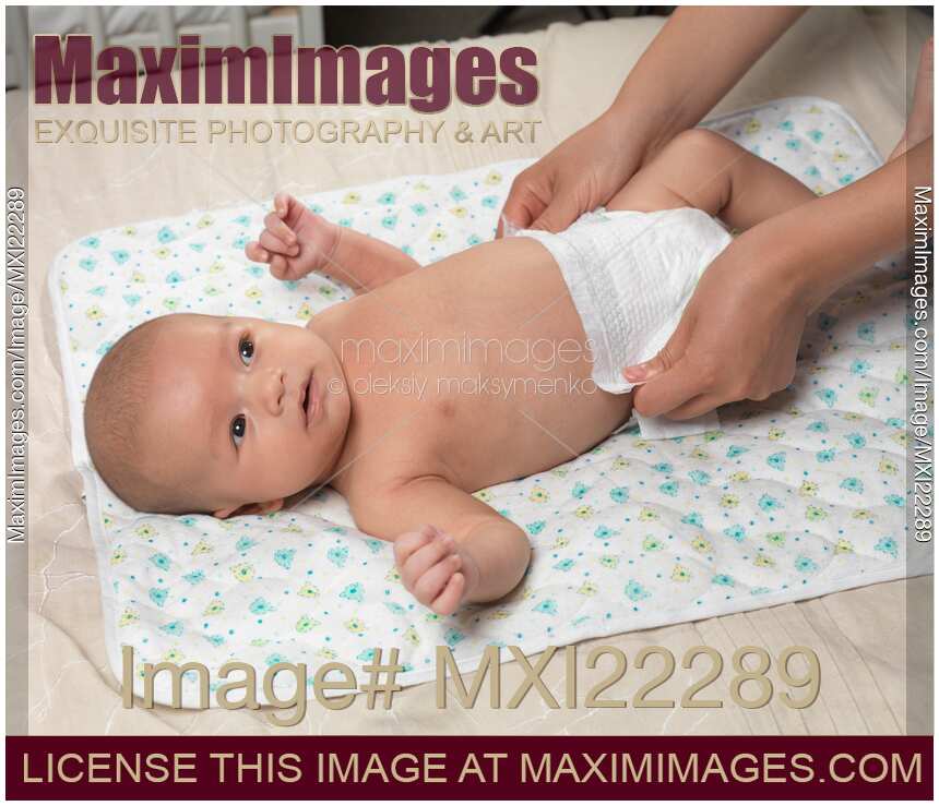 Mother Changing Diaper of a Baby Boy