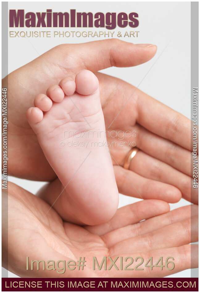Mother Holding Baby's Foot in Her Hands