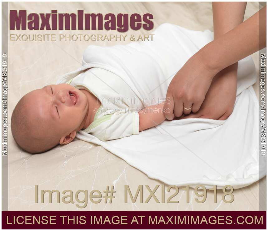 Photo of Mother Swaddling a Baby Stock Image MXI21918