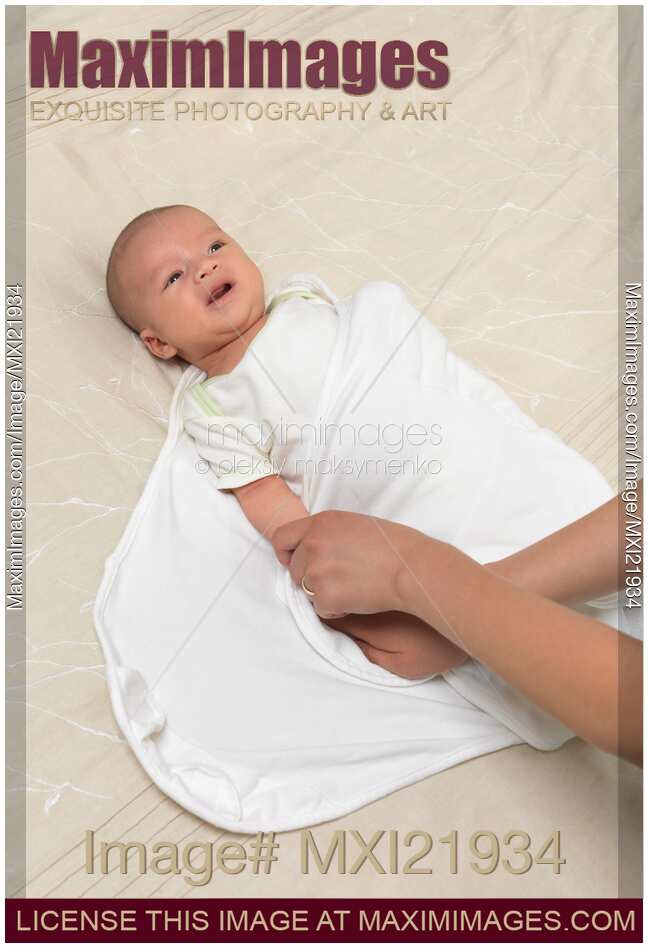 Mother Swaddling a Baby