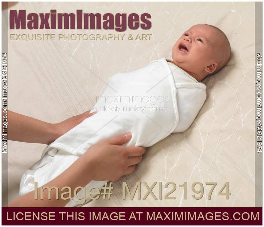 Mother Swaddling a Baby