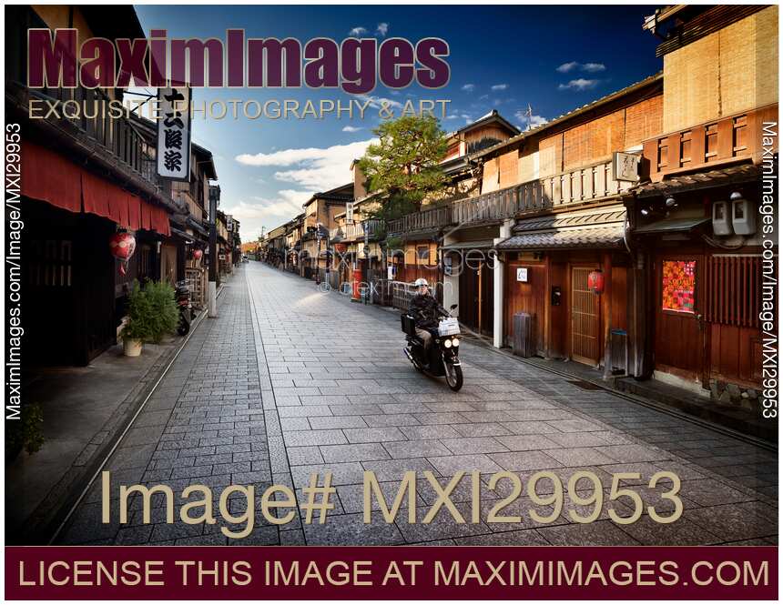 Motorcyclist on Hanamikoji Dori street in Gion district in the morning Kyoto Japan