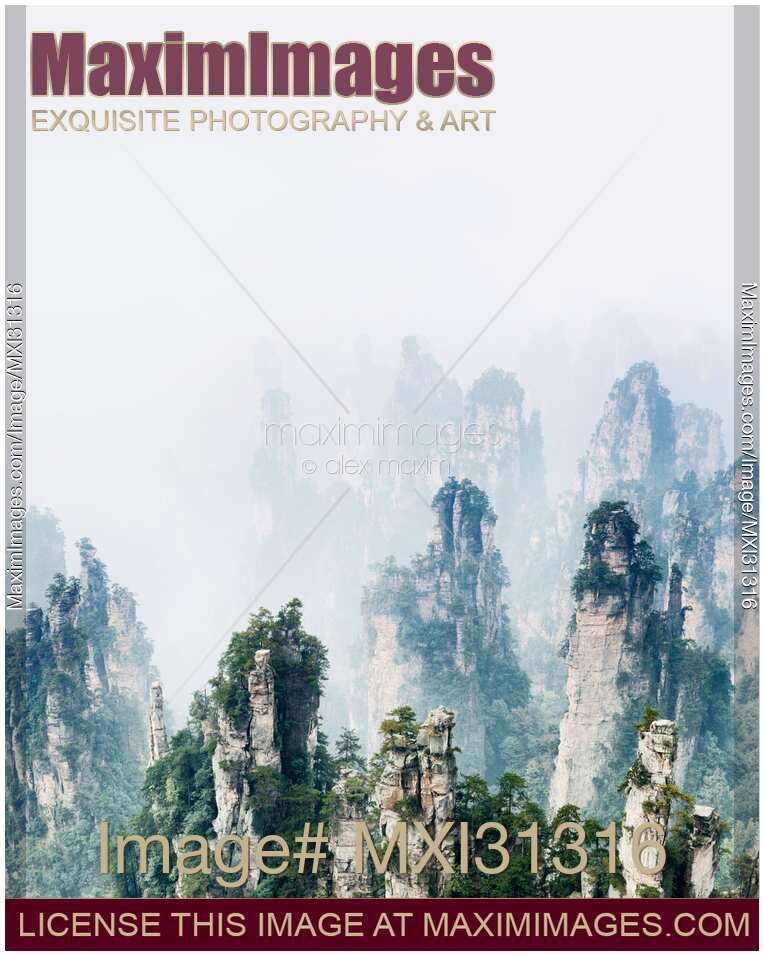 Mountain spires rising from thick milky fog at Zhangjiajie National Park nature landscape