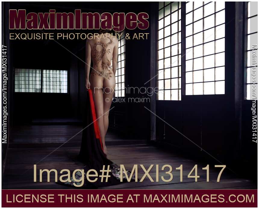 Mysterious asian woman with a dragon body tattoo art on her naked back undressed in a dark Japanese house Yakuza lady