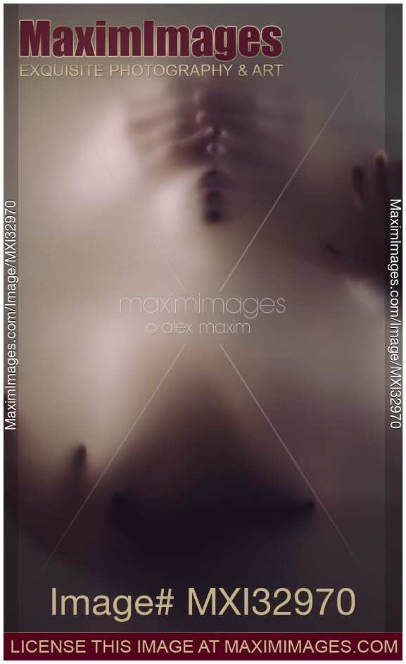 Mysterious dark sensual portrait of woman with her eyes closed by ghostly male hands from behind in hazy dream