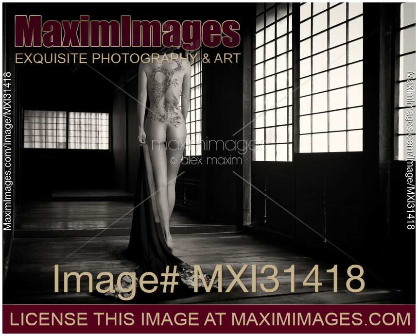 Mysterious Japanese woman with a dragon tattoo of Yakuza clan on her naked back in a dark empty house Black and white nude art