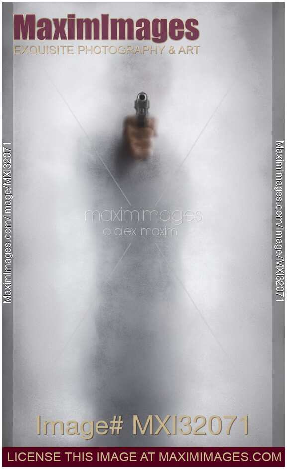 Mysterious man behind glass pointing a gun out of bright white light Thriller and Crime concept