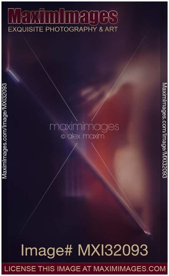Mysterious romantic concept of a woman playing cello in dark dream-like haze behind blurry glass