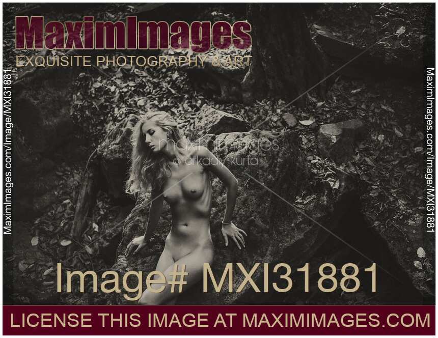 Naked woman in a forest with a tranquil thoughtful expression Fine art nude