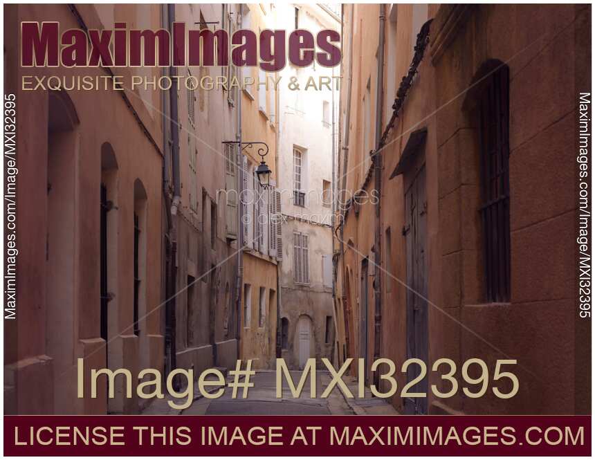 Narrow passage between old crooked houses on a street of a French city Aix-en-Provence