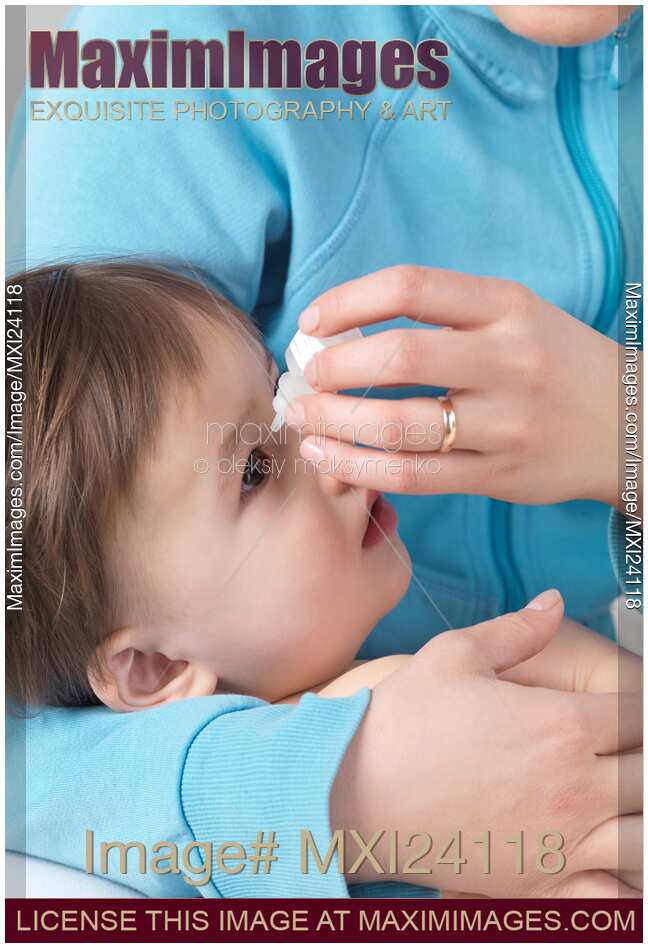 Stock photo Nother giving baby eye drops MaximImages Image MXI24118