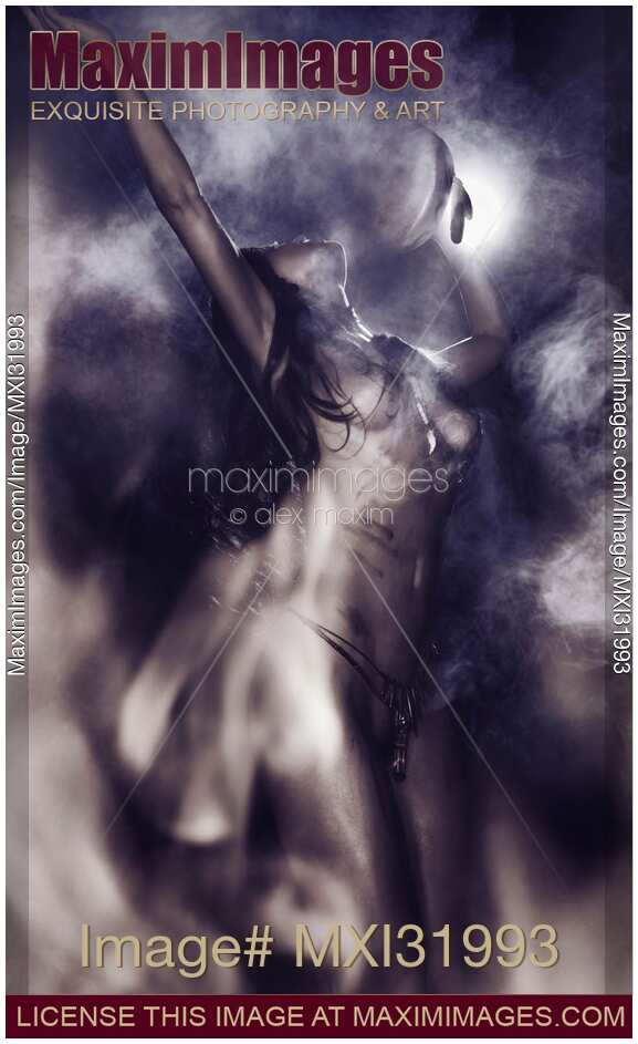 Nude aboriginal tribal woman shamanic purification ritual with a drum dancing at night in front of bonfire on full moon