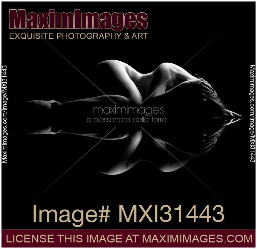 Nude body outline of a woman lying curled-up black and white