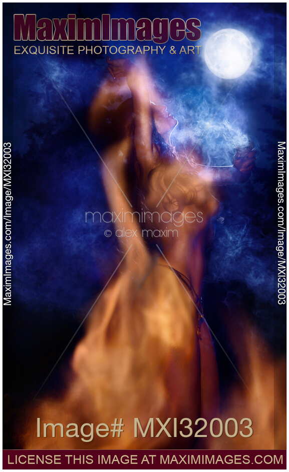 Nude native woman performing shamanic witchcraft ritual dancing by the fire in light of a full moon at night