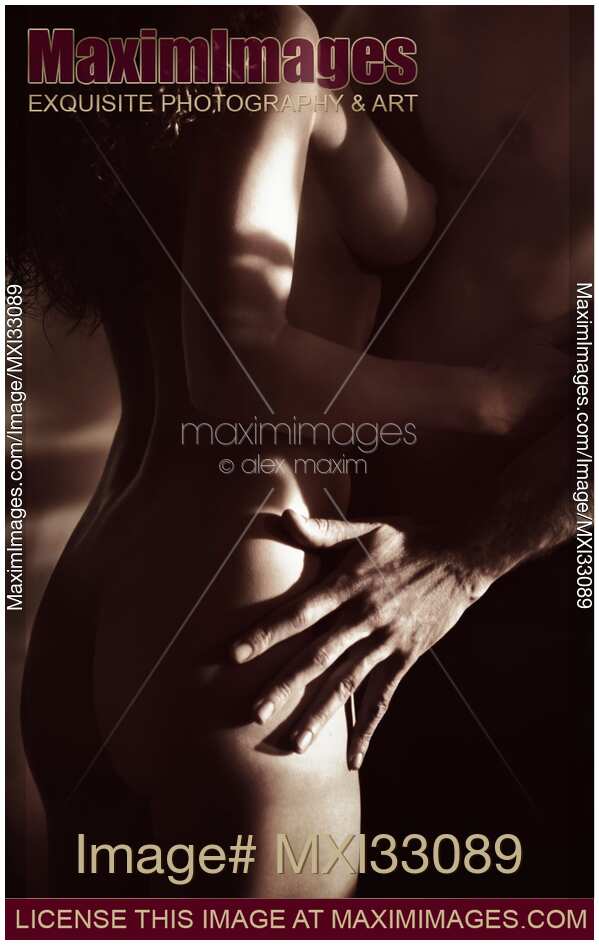 Nude woman and a man embracing Black and white artistic sensual closeup of body parts
