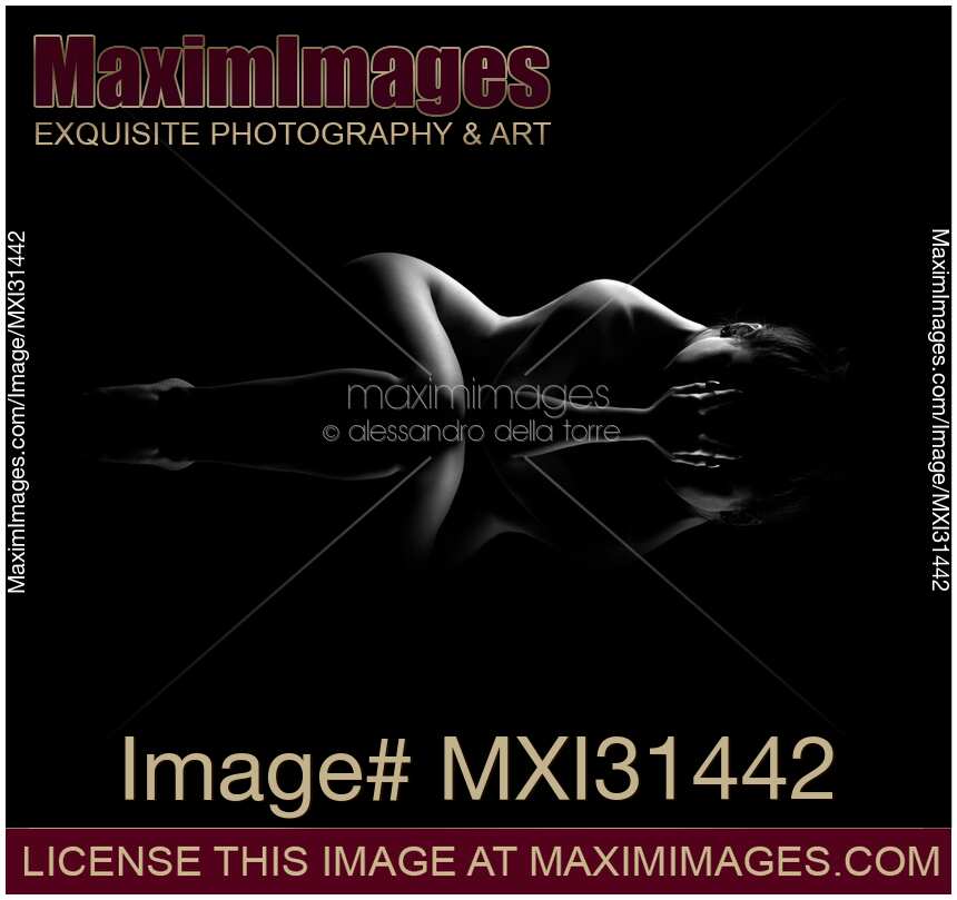 Nude woman body outline lying on black reflective background black and white