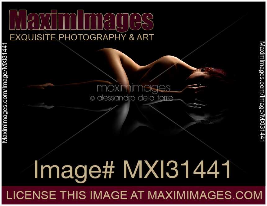 Nude woman body outline on black background with black and white reflection