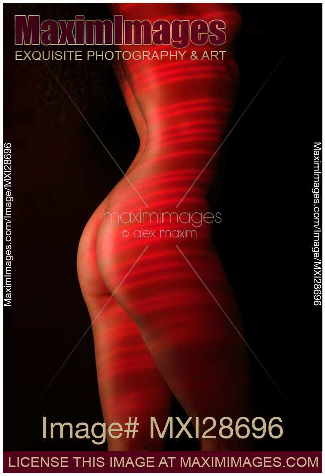 Nude woman body with red laser stripes on skin