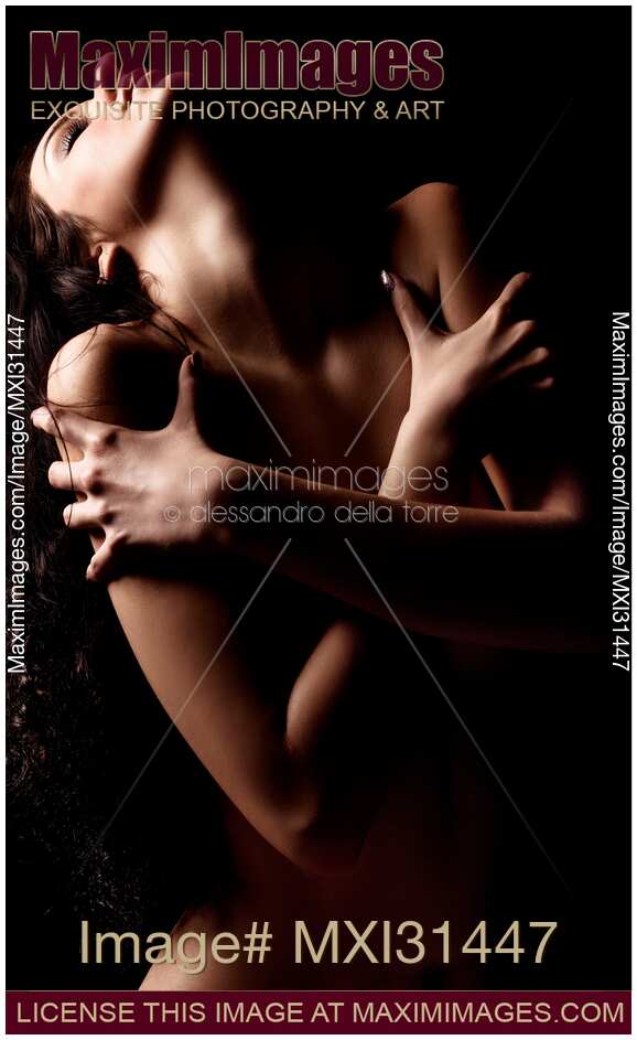Nude woman holding crossed arms around her chest