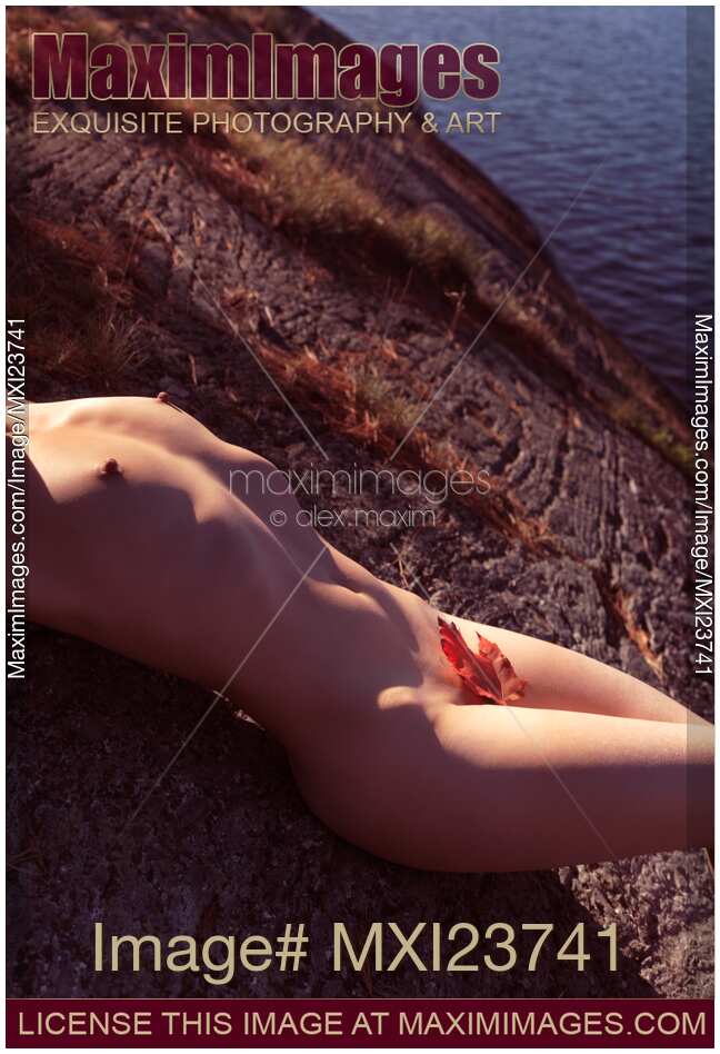 Nude Woman Lying on Rocks by the Water
