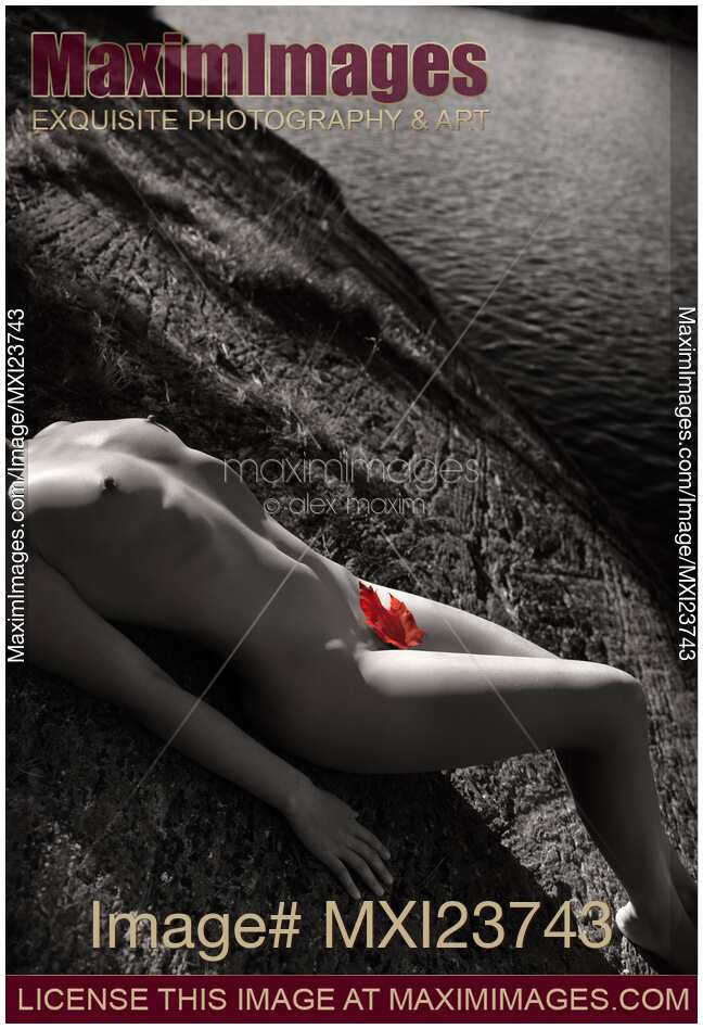 Nude Woman Lying on Rocks by the Water