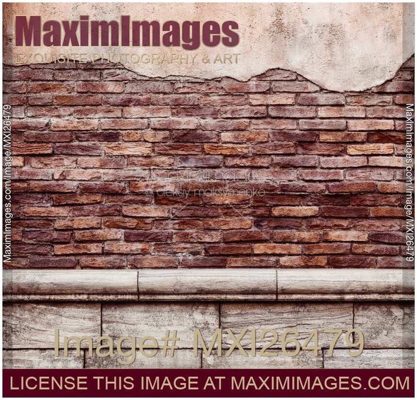 Old grungy brick wall with peeled stucco