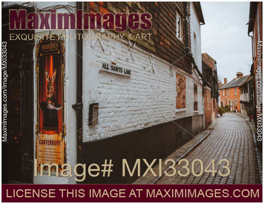 Old narrow cobbled street with houses and pubs in Canterbury England