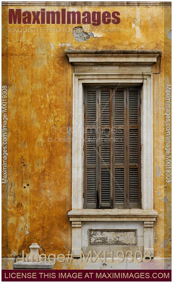 Old weathered wall with shuttered window