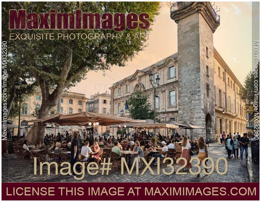 Open-air restaurants busy with people in Aix-en-Provence Southern France sunset city scenery