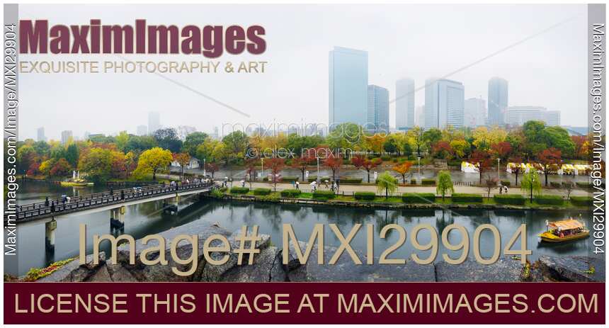 Osaka Castle Park canal with boats and Gokurakubashi bridge panoramic misty autumn city scenery
