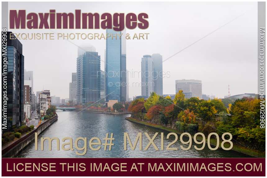 Osaka financial district towers on the banks of Okawa River in colorful misty autumn scenery