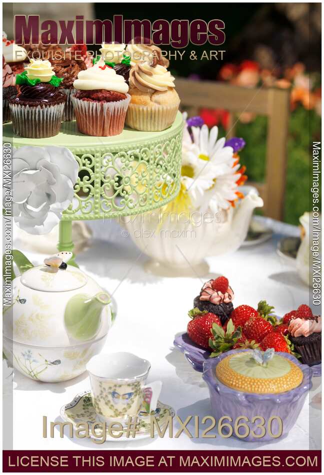Outdoor tea party table with cupcakes