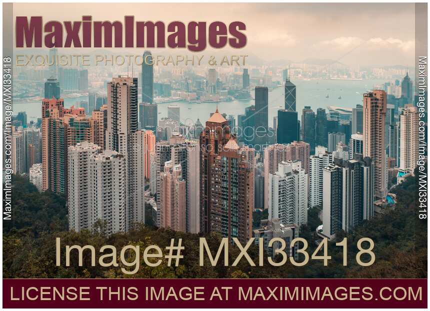 Panoramic sunset scenery of Hong Kong city in China with high-rise modern buildings in the mist