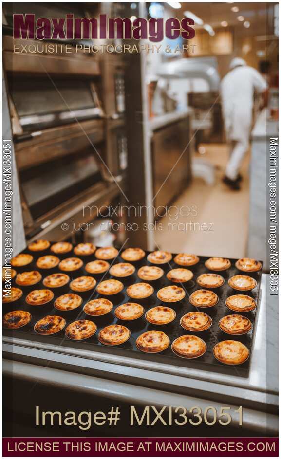 Pasteis de Nata traditional Portuguese custard tarts on a tray in a cafe
