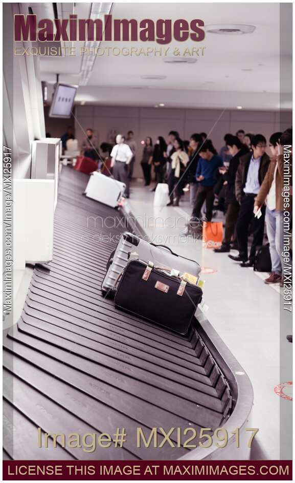 People at airport baggage claim conveyor