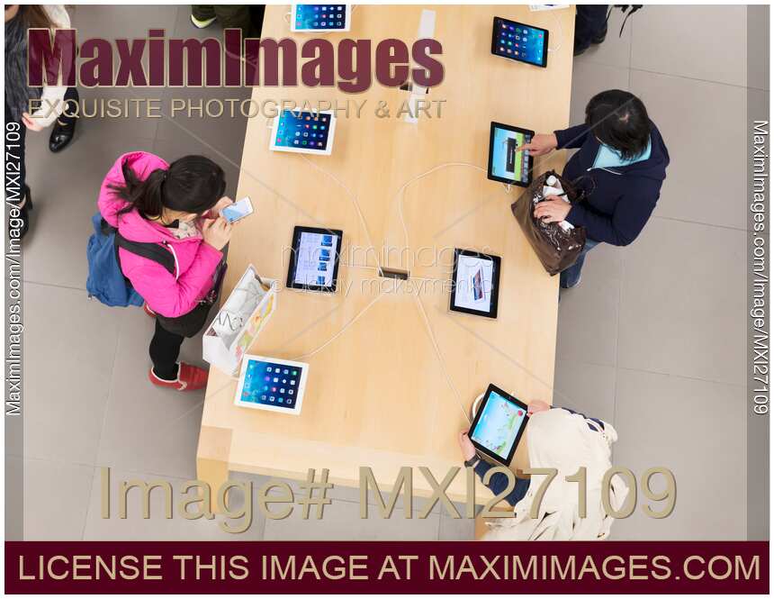 People at Apple store trying new iPads