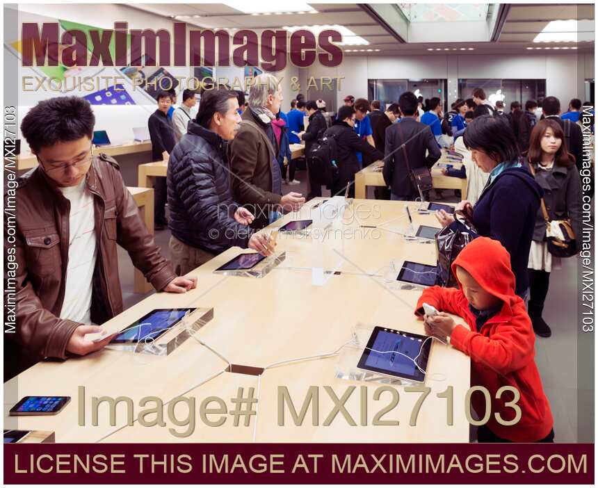 People at Apple store trying new iPhones