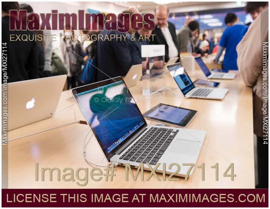 People at Apple store trying new MacBook laptops