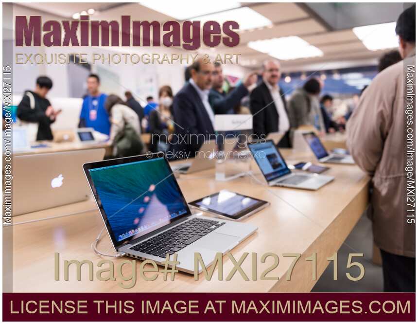 People at Apple store trying new MacBook laptops