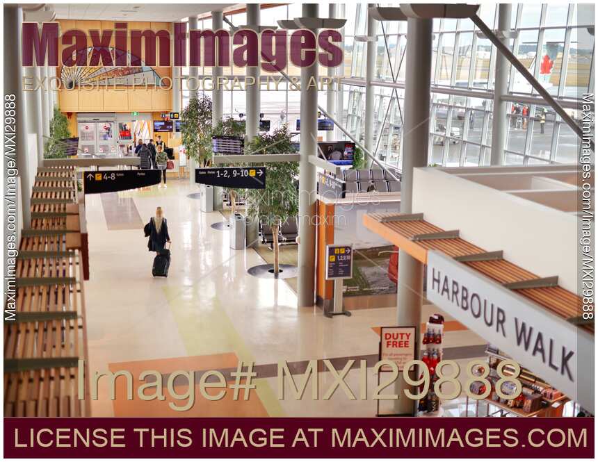 People at departure gates interior at Victoria International Airport