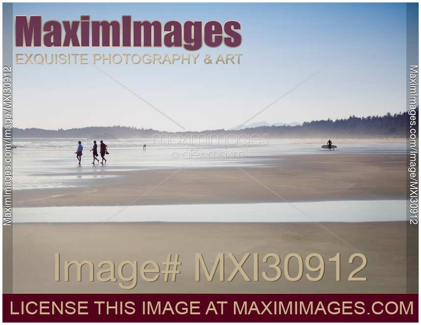 People at the Pacific Rim National Park walking along the sandy beach of Pacific ocean